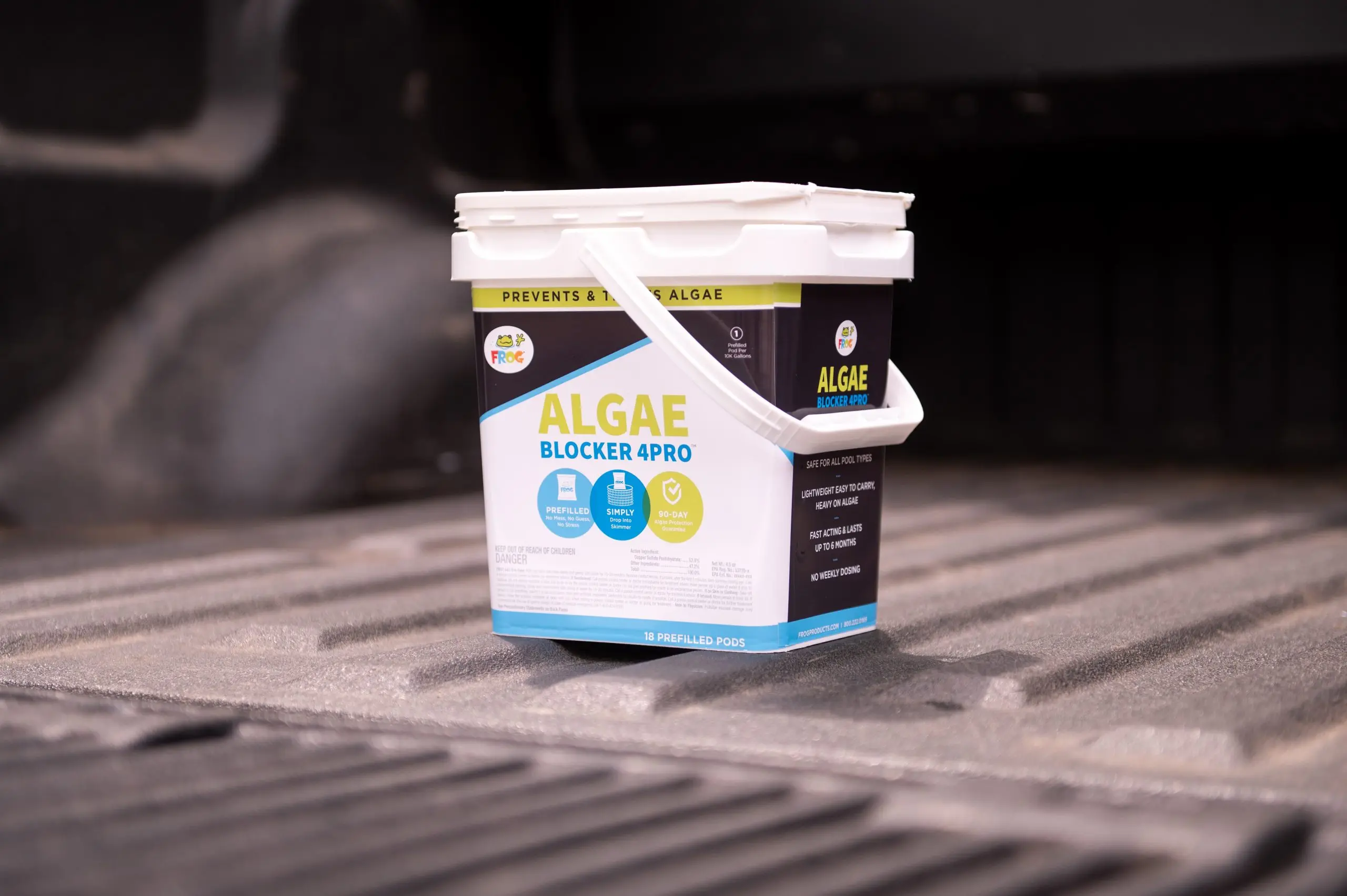 White bucket of Algae Blocker 4PRO sitting on textured surface.